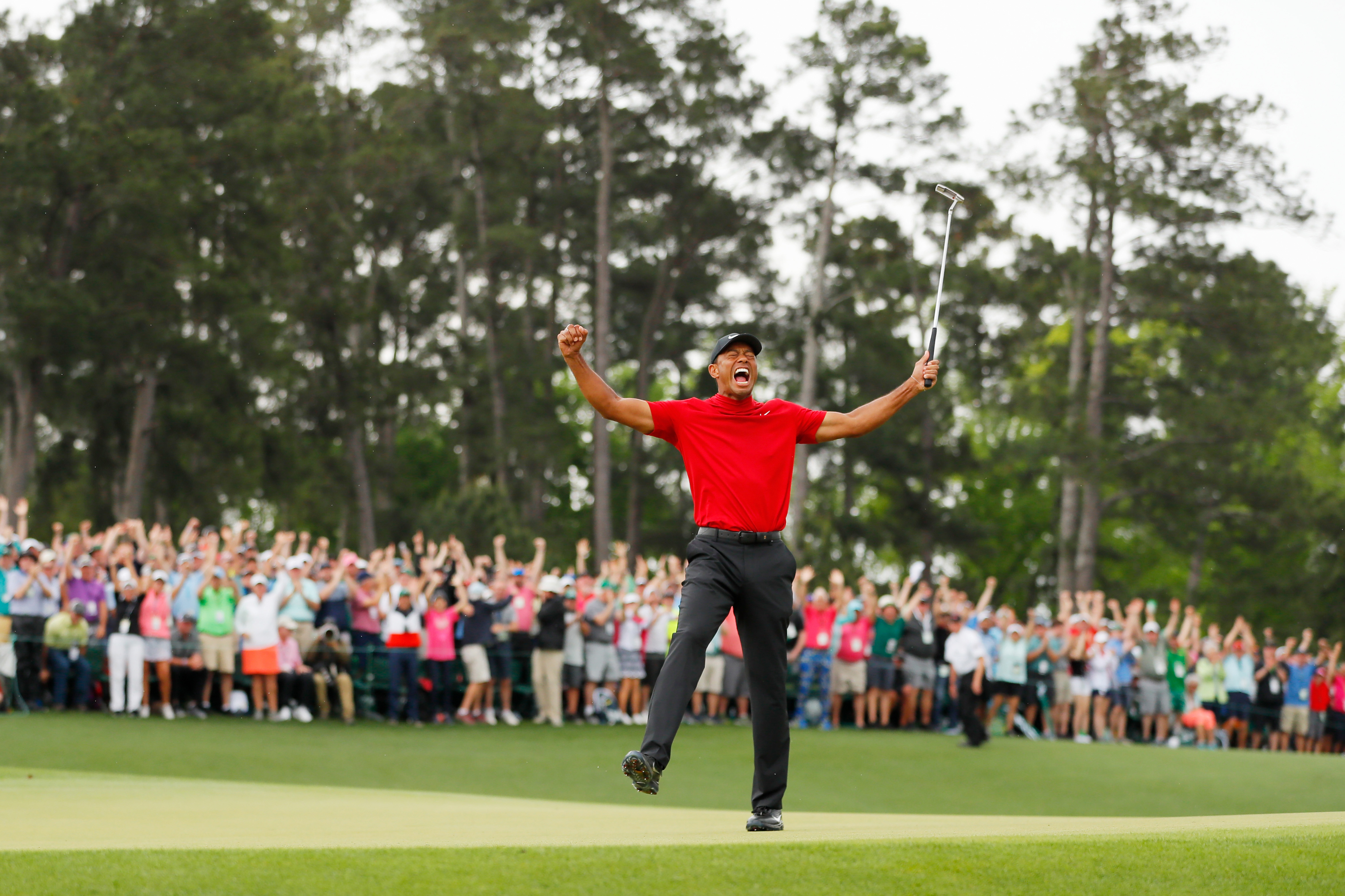 Tiger Woods of the United States celebrates after making his putt on the 18th green to win the Masters at Augusta National Golf Club on April 14, 2019 in Augusta, Georgia. (Photo by Kevin C. Cox/Getty Images)
