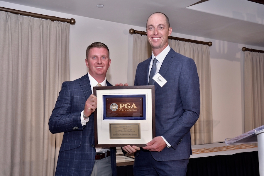 Jeremy Beck holding award