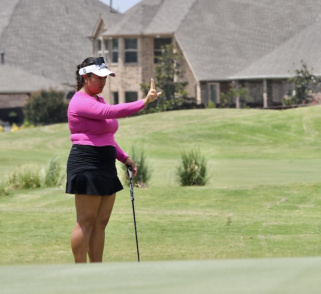 Mary Carson lining up a putt.