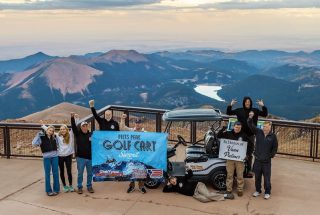 Team picture atop Pikes Peak following the The Trojan Lithium OnePack powered a golf cart driven by Austin King, owner of World Famous Golf Carts, to the summit of Pikes Peak.