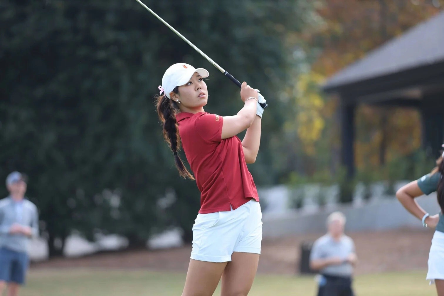 Picture of golfer Jasmine Koo swinging a golf club